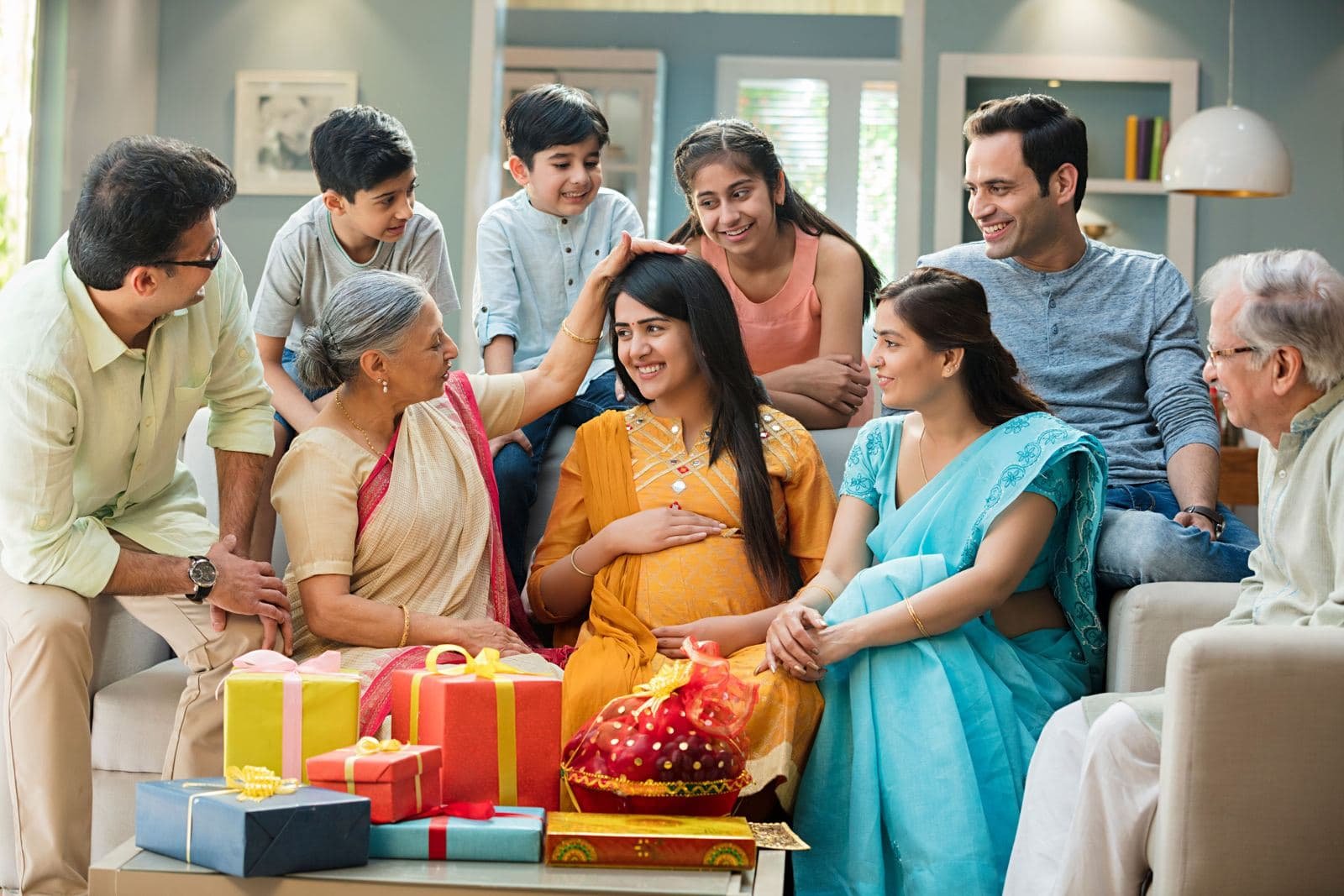 Family gathered with gifts around an expecting mother