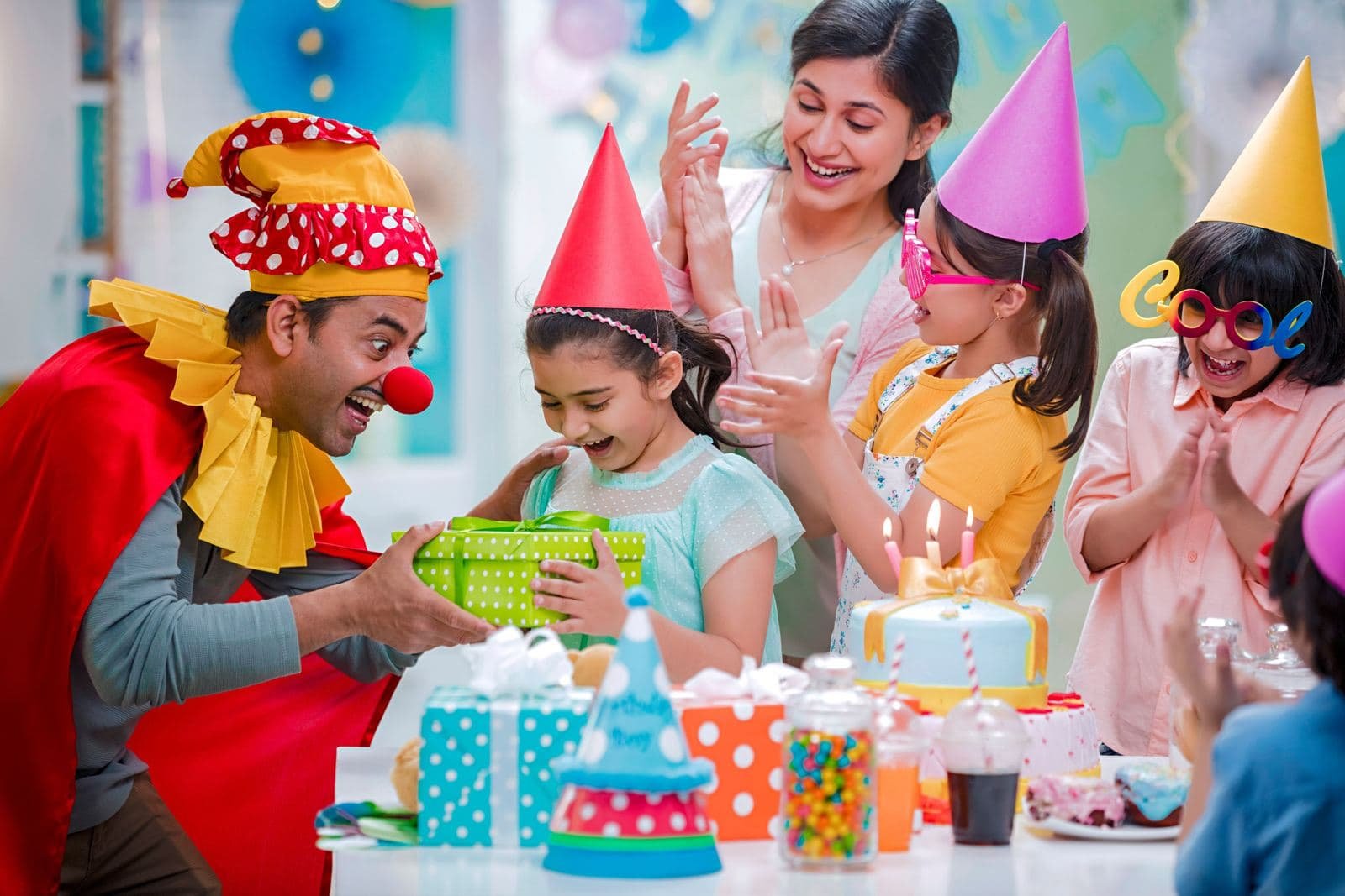 Children celebrating a birthday with cake and party hats