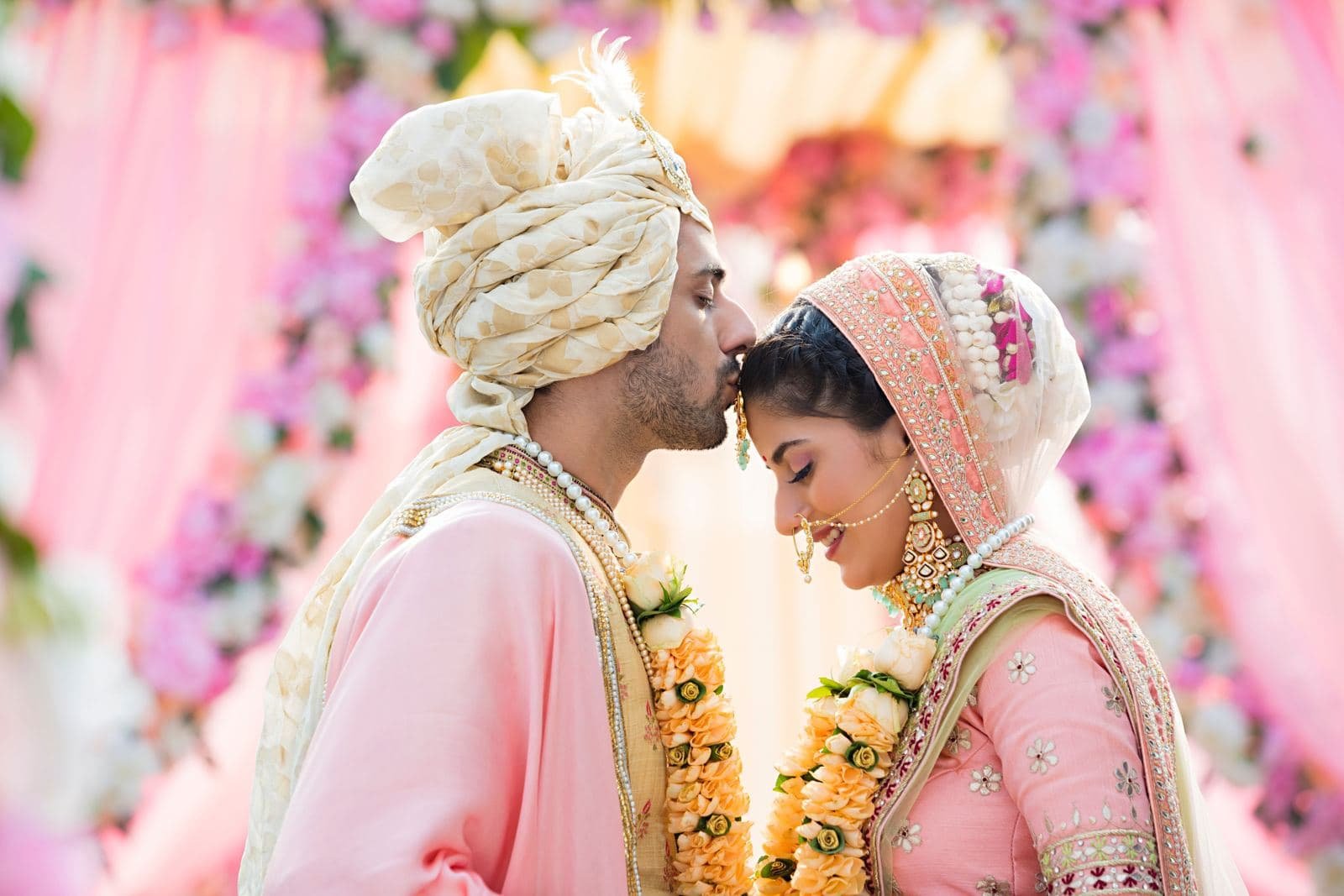Bride and groom touching foreheads during the varmala