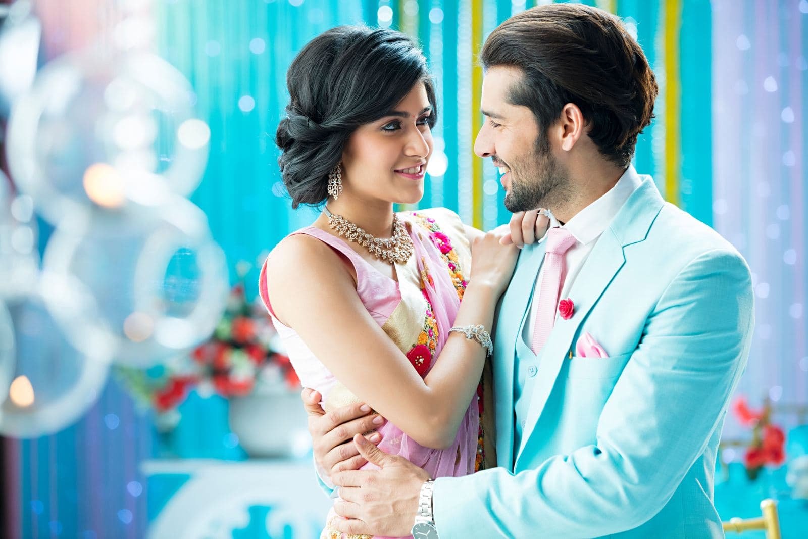 Engaged couple embracing and smiling