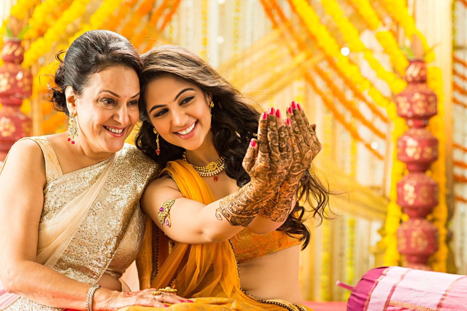 Mother and daughter laughing at a mehendi ceremony
