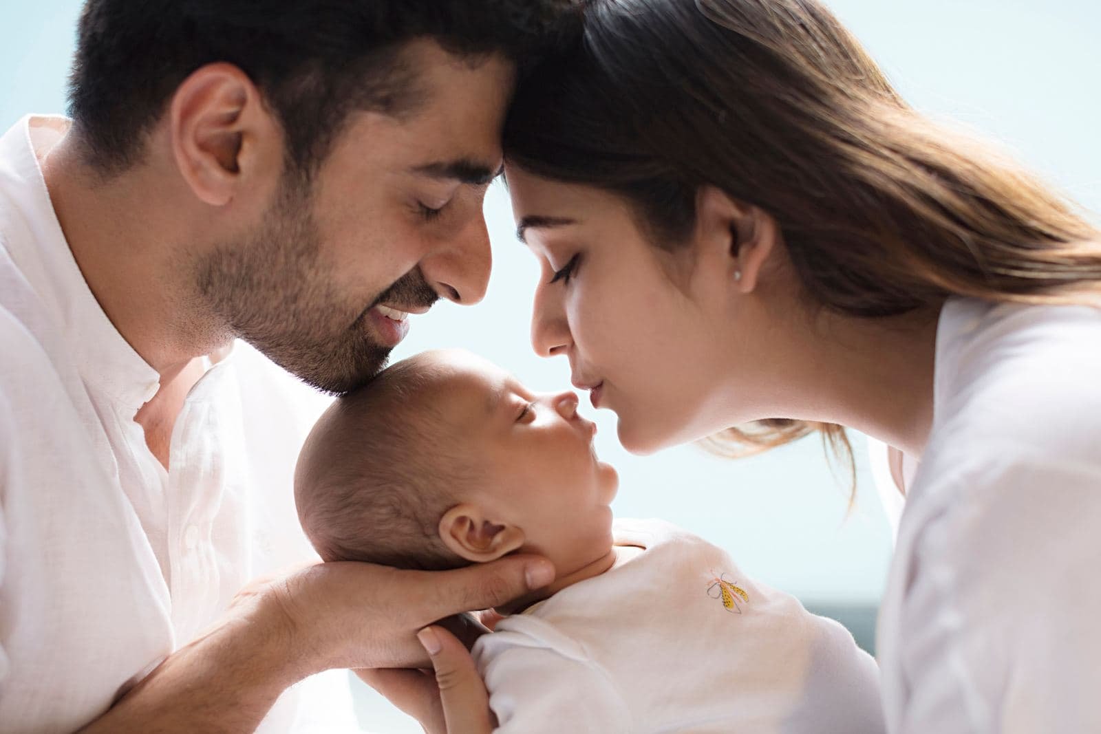 Parents tenderly holding their newborn baby