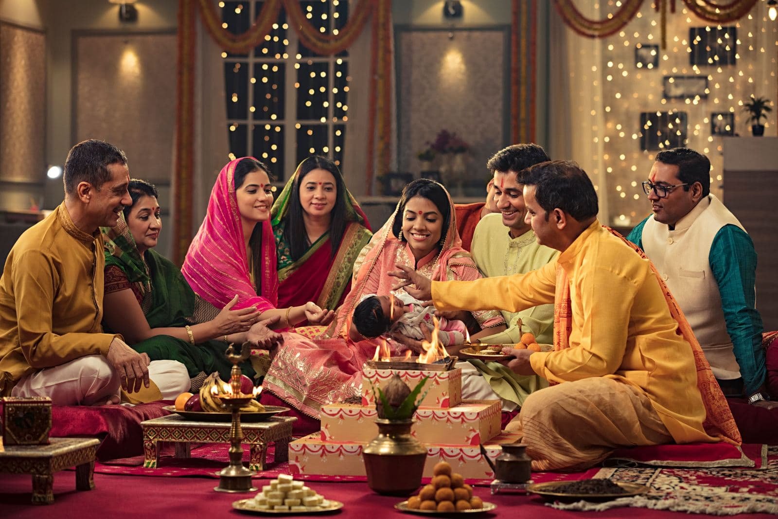 Family seated together for a puja ceremony