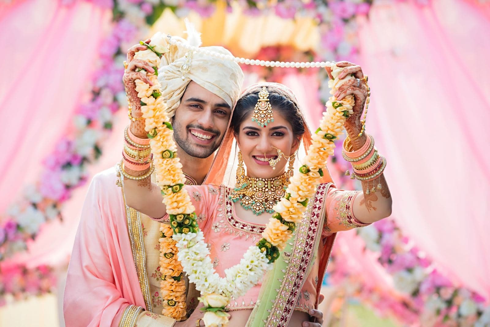 Bride and groom exchanging flower garlands