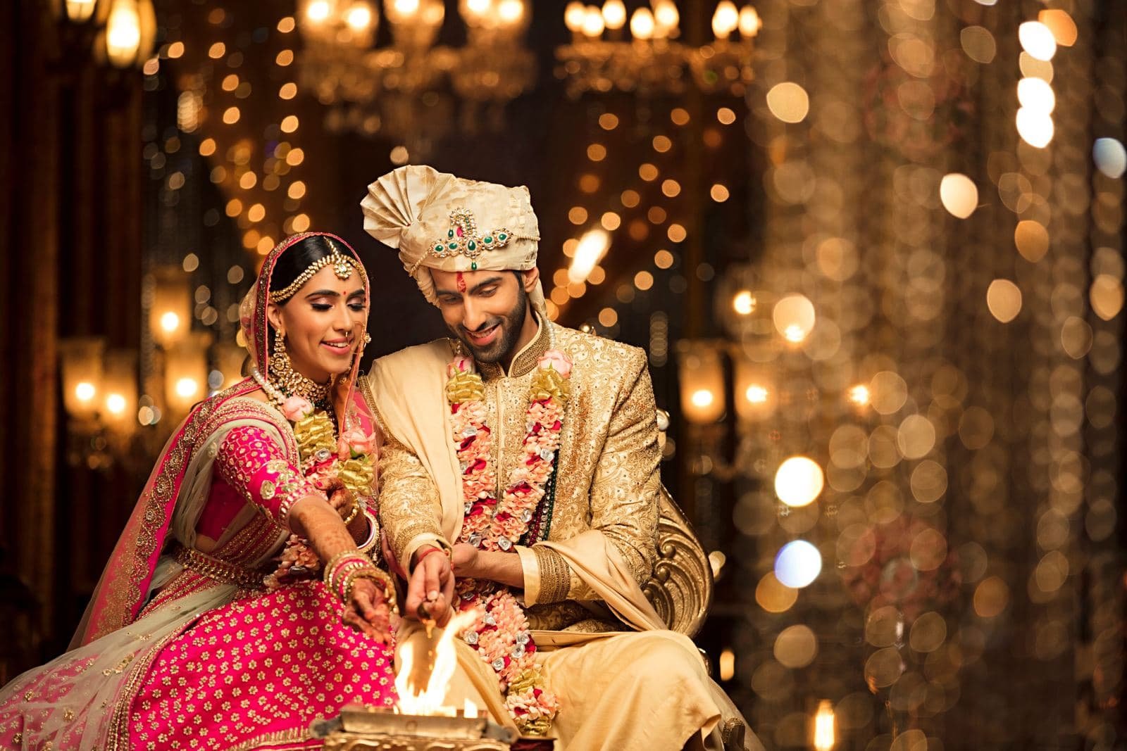 Couple performing a wedding ritual by candlelight